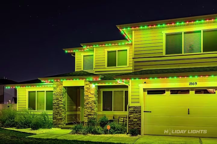 Permanent roofline lights installed along the full eaves of a New York home
