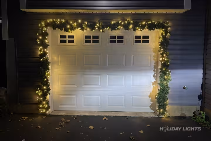 Professional residential Christmas light installation in Hounsfield, New York — Garage Door Garland Display