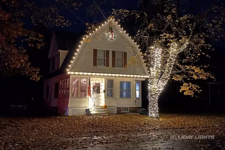 Professional residential Christmas light installation in Le Ray, New York — Roofline and Tree Trunk Wrapping