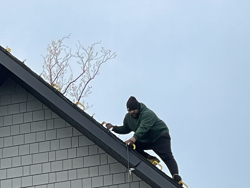 Holiday Lights Decor crew installing Christmas lights